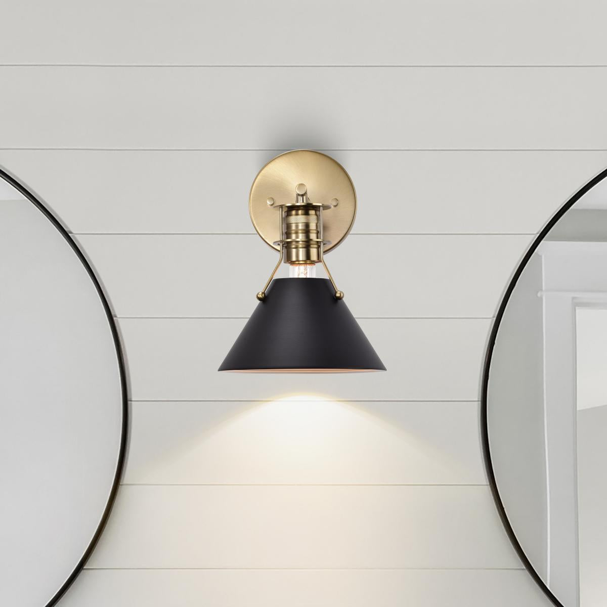 Satco Outpost 1-Light Wall Sconce with matte black finish and burnished brass accents, LED lighting fixture for modern interior decor.