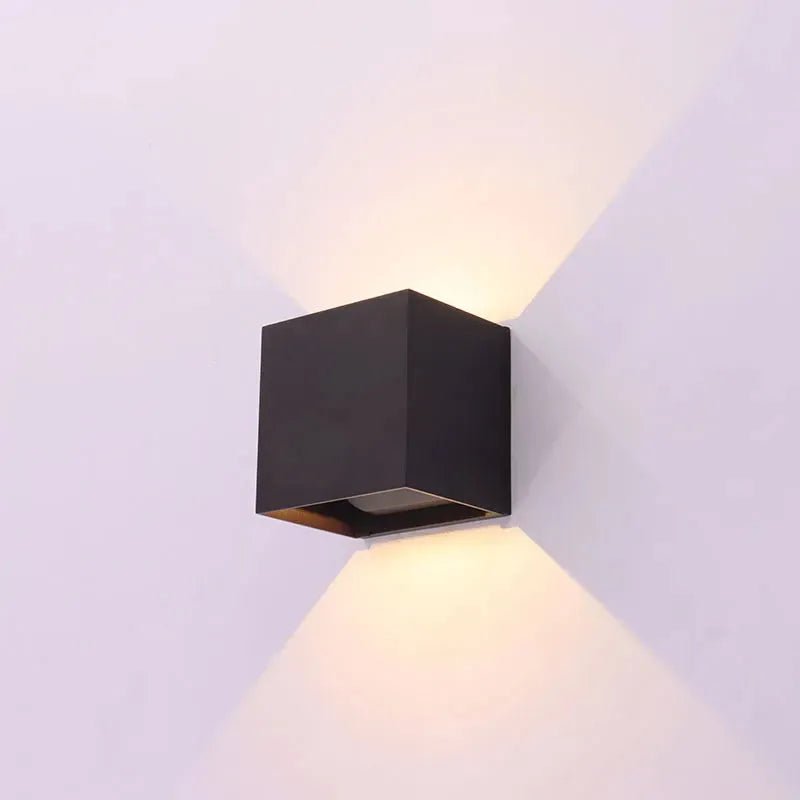 Bronze wall-mounted exterior lighting fixture with adjustable beam angle and 15W CCT for versatile outdoor illumination.