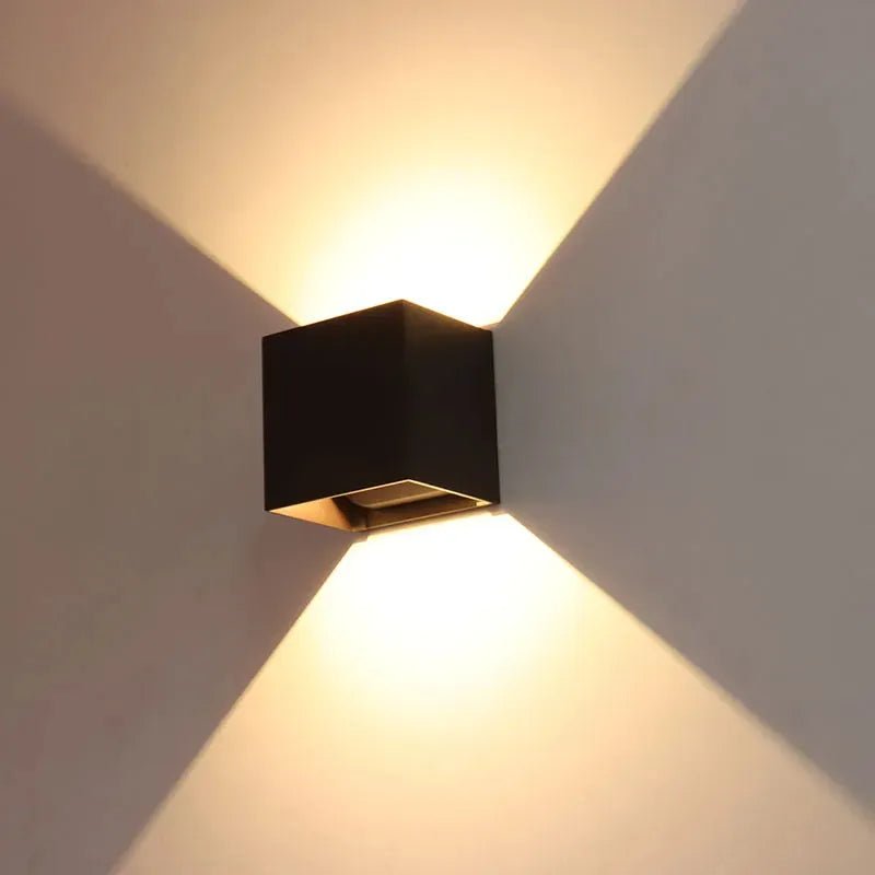Bronze wall-mounted exterior light fixture with adjustable beam angle and 15W CCT, designed for outdoor lighting by Westgate