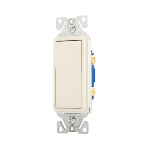 Cooper Eaton 15A standard decorator switch in light almond color, mounted on wall with wiring visible.
