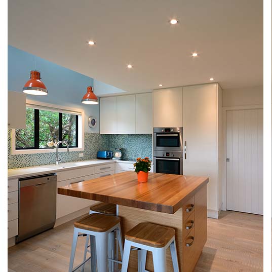 Nicor 4-inch LED gimbal recessed downlight in white with adjustable CCT for retrofit lighting, shown in installation image.